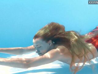 Petite teen Ivi Rein endures the free naked swimming
