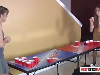 Two beautiful girls play strip beer pong